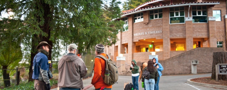 Students and professor outside the Fisheries & Wildlife building